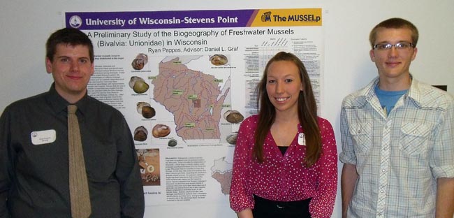Ryan Pappas, Caitlin Luebke, and Charlie Jordan posing with one of the UWSP Mussel Group posters presented at the 2013 College of Letters and Science Undergraduate Research Symposium.