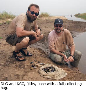Daniel Graf and Kevin Cummings, filthy, pose with a full collecting bag.