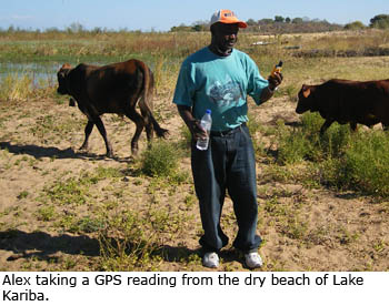 Alex Chilala take a GPS reading from the dry beach of Lake Kariba.